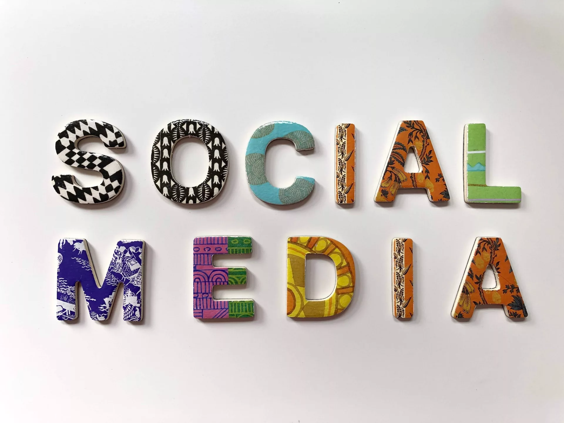 Colorful clay letters forming the words 'social media' as a representation of increasing website traffic through social media.